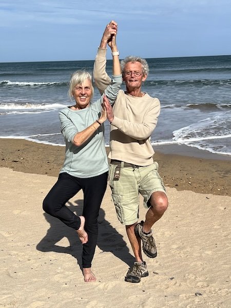 Parents of Surya Bee - Deborah Hill in Tree Pose on beach in Northumberland.